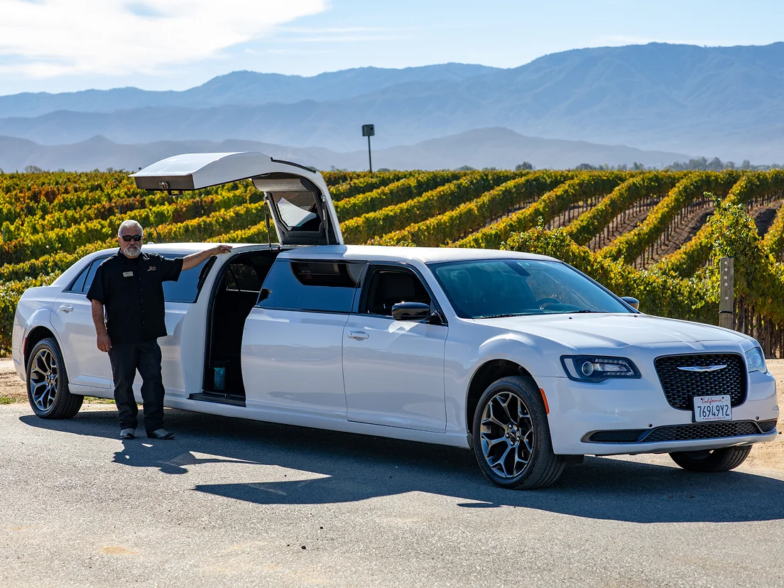 Temecula Limos white limousine with chauffeur at a vineyard in Temecula