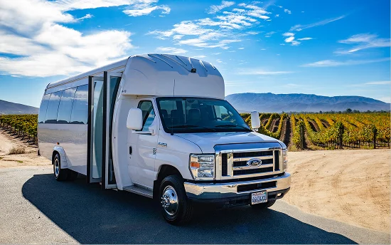 Temecula Limos white shuttle bus at a vineyard in Temecula