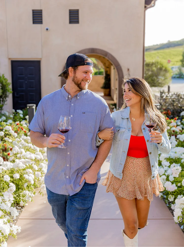 Temecula Limos wine tour experience with a couple enjoying wine at a vineyard